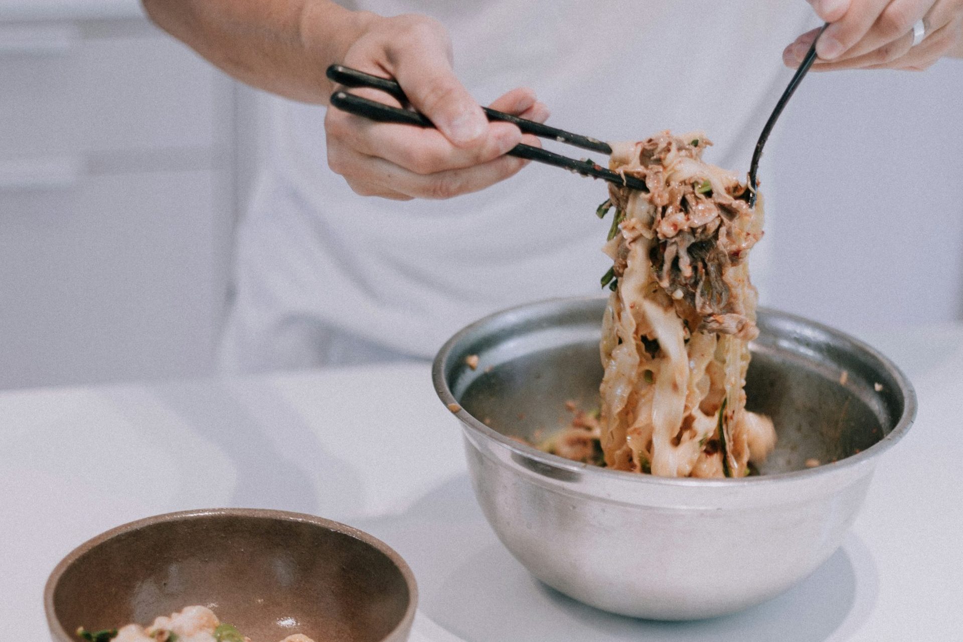 person holding stainless steel spoon and fork